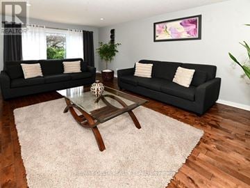Ottawa townhouse for rent - A living room with black couches and a glass coffee table.