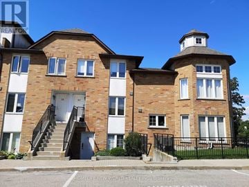 Toronto (Bathurst Manor) townhouse for rent - A brick building with a white door and windows.