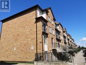 Toronto (Bathurst Manor) townhouse for rent - A brick building with a sign that says "HOMELIFE NEWBORN".