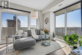 Toronto (Waterfront Communities) condo for rent - A living room with a grey sofa and a glass table.