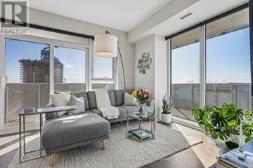 Toronto (Waterfront Communities) condo for rent - A living room with a grey sofa and a glass table.