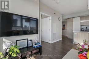 Toronto (Waterfront Communities) condo for rent - A living room with a flat screen TV and a white door.