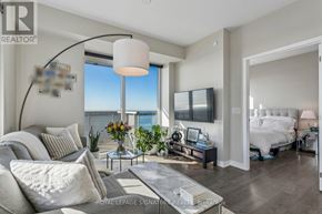 Toronto (Waterfront Communities) condo for rent - A living room with a large window overlooking the water.