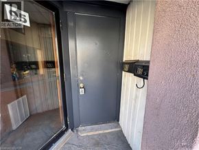Kitchener apartment for rent - A black door with a silver handle and a number 97 on the wall.