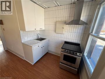 Kitchener apartment for rent - A kitchen with a stove and sink.
