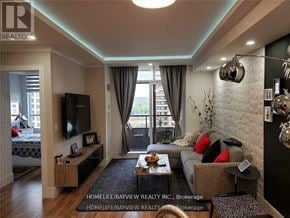 Vaughan (Maple) condo for rent - A living room with a couch, a coffee table, and a television.