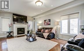 Brampton (Bram West) apartment for rent - A living room with a fireplace and a couch.