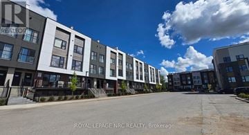 St. Catharines (E. Chester) townhouse for rent - A row of modern apartment buildings with the text "ROYAL LEPAGE NRC REALTY, Brokerage" on the bottom.