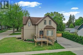 Collingwood duplex for rent - A house with a brown roof and a deck in the front yard.
