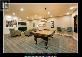 Woodstock (Woodstock - South) condo for rent - A pool table in a room with a bookshelf and chairs.