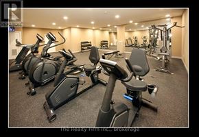 Woodstock (Woodstock - South) condo for rent - A gym with a row of stationary bikes and other exercise equipment.