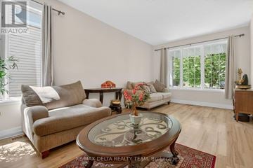 Ottawa apartment for rent - A living room with a glass coffee table and a couch.