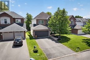 Ottawa apartment for rent - A car is parked in a driveway in front of a house.