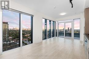 Toronto (Dovercourt-Wallace Emerson-Junction) condo for rent - A spacious room with a view of the cityscape through large windows.
