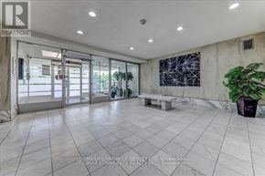 Toronto (Humber Summit) condo for rent - A spacious room with tiled flooring and a large abstract painting on the wall.