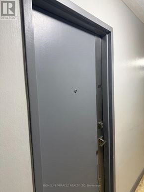 Toronto (Humber Summit) condo for rent - A grey door with a handle and a keyhole.