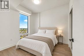 Toronto (Dovercourt-Wallace Emerson-Junction) condo for rent - A bedroom with a large bed and a view of the city.