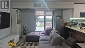 Toronto (Yorkdale-Glen Park) condo for rent - A realtor's office with a couch and a window showing an outdoor view.