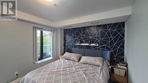 Toronto (Yorkdale-Glen Park) condo for rent - A bedroom with a bed, nightstand, and window.