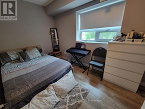 Waterloo condo for rent - A bedroom with a bed, desk, and chair.