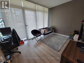 Waterloo condo for rent - A room with a desk, chairs, and a window with blinds.
