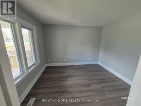 Oshawa (Central) apartment for rent - A room with wooden flooring and a window at the Brokerage of Right at Home Realty.