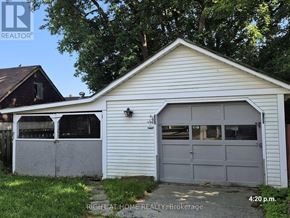 Oshawa (Central) apartment for rent - A garage with a white exterior and a grey door is shown.