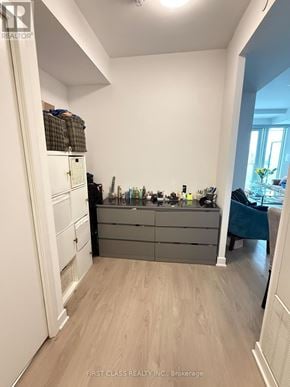 Mississauga (City Centre) condo for rent - A kitchen with a white refrigerator, a wooden floor, and a blue chair.