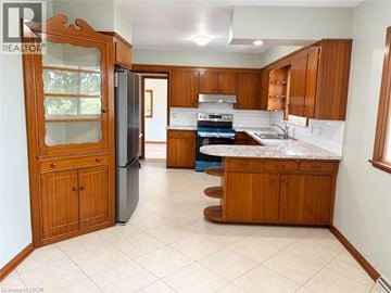West Lincoln apartment for rent - A kitchen with wooden cabinets and a refrigerator.