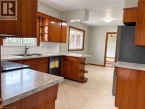 West Lincoln apartment for rent - A kitchen with wooden cabinets and a granite countertop.