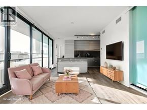 Burnaby apartment for rent - A modern living room with a pink sofa and a wooden coffee table.
