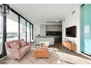 Burnaby apartment for rent - A modern living room with a pink sofa and a wooden coffee table.