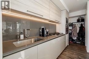 Burnaby apartment for rent - A modern kitchen with a sink and a countertop.