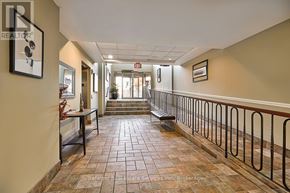 Hamilton (Waterdown) condo for rent - A hallway with a bench and a plant on the left side.