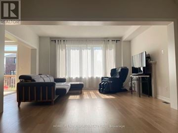 Georgina (Sutton & Jackson's Point) apartment for rent - A living room with a black couch and a television.