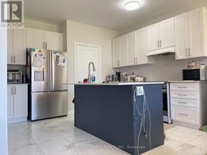 Georgina (Sutton & Jackson's Point) apartment for rent - A kitchen with a black island in the middle.