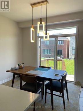 Georgina (Sutton & Jackson's Point) apartment for rent - A dining room with a table and chairs and a view of a building outside.
