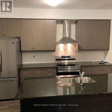 Wasaga Beach townhouse for rent - A kitchen with a sink and a refrigerator.