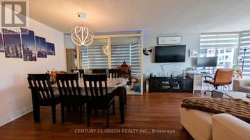 Mississauga (City Centre) condo for rent - A well-lit living room with a dining table and chairs.