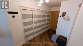Mississauga (City Centre) condo for rent - A room with a white door and a wooden floor.