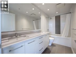 Burnaby apartment for rent - A white bathroom with a toilet, sink, and bathtub.