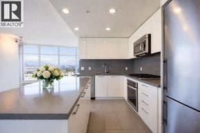 Burnaby apartment for rent - A modern kitchen with a refrigerator, stove, and oven.