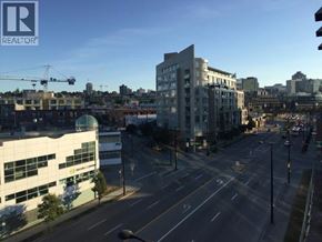 Vancouver apartment for rent - A city street with a building that says REALTOR.