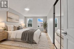 Ottawa apartment for rent - A bedroom with a large bed and a painting on the wall.