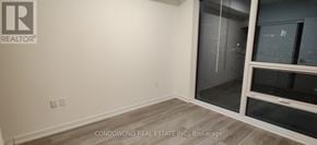 Toronto (Waterfront Communities) condo for rent - A room with a window and a wall with a logo that says REALTOR.
