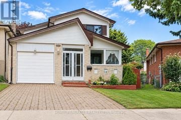Toronto (Malvern) apartment for rent - A two-story house with a white garage door and a brick driveway.