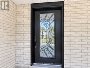 Toronto (Malvern) apartment for rent - A glass door with a black frame and a glass window with a design on it.