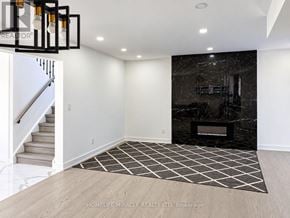 Toronto (Malvern) apartment for rent - A black and white checkered rug sits in front of a black marble fireplace.