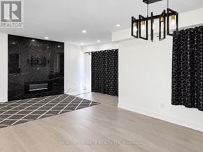 Toronto (Malvern) apartment for rent - A modern living room with a black marble fireplace and a wooden floor.