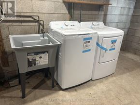 West Lincoln (Bismark/Wellandport) apartment for rent - A white washing machine and dryer are on display in a laundry room.